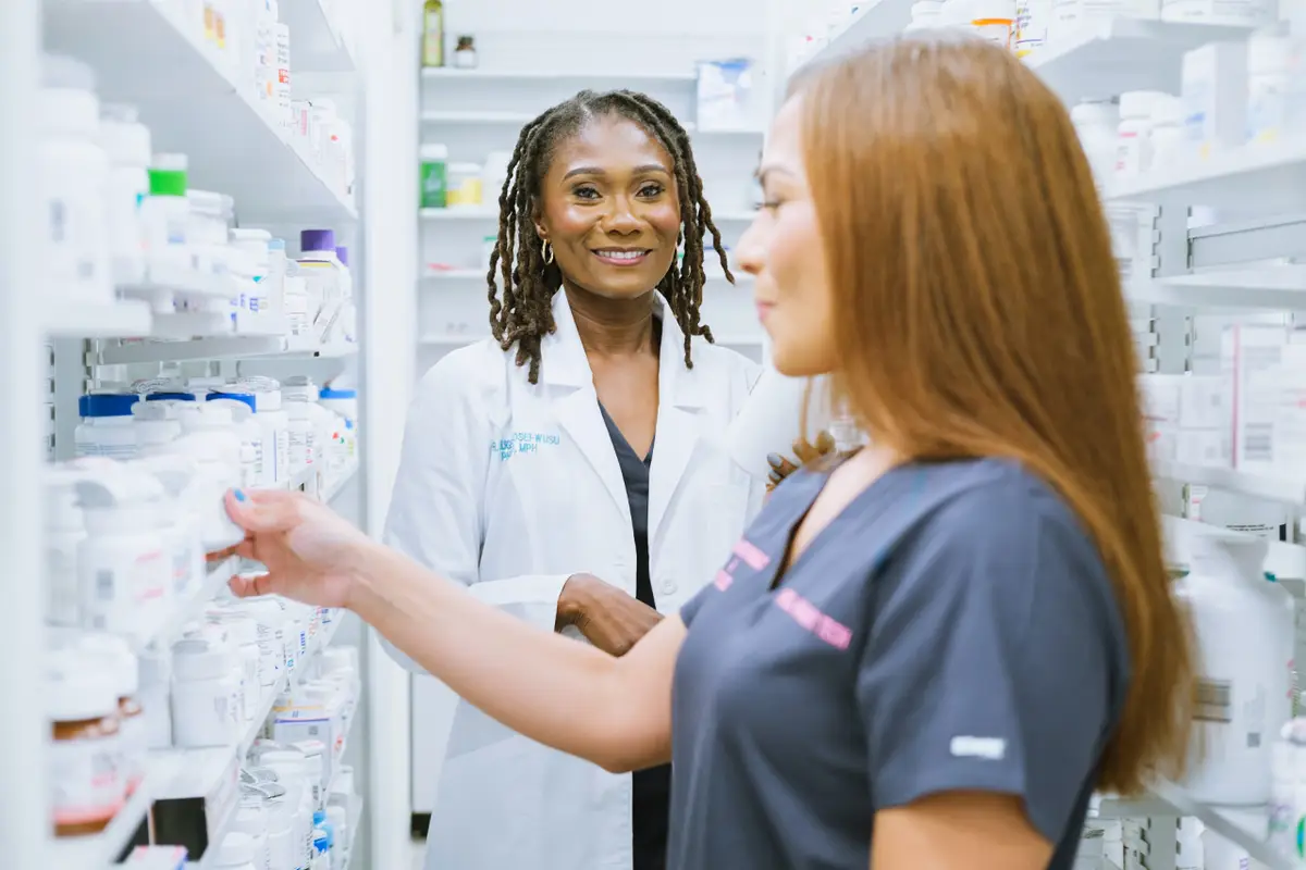 Pharmacist reviewing medications at the shelves